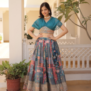 Woman in traditional outfit standing in a decorative indoor setting with plants.