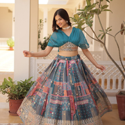 Woman in a traditional outfit with a colorful skirt indoors