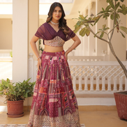 Woman in traditional outfit standing in a decorated indoor setting with plants.